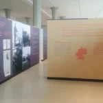 Museumsausstellung mit lila und beigen Tafeln zur deutsch-niederländischen Grenzgebietsdebatte nach dem Zweiten Weltkrieg.