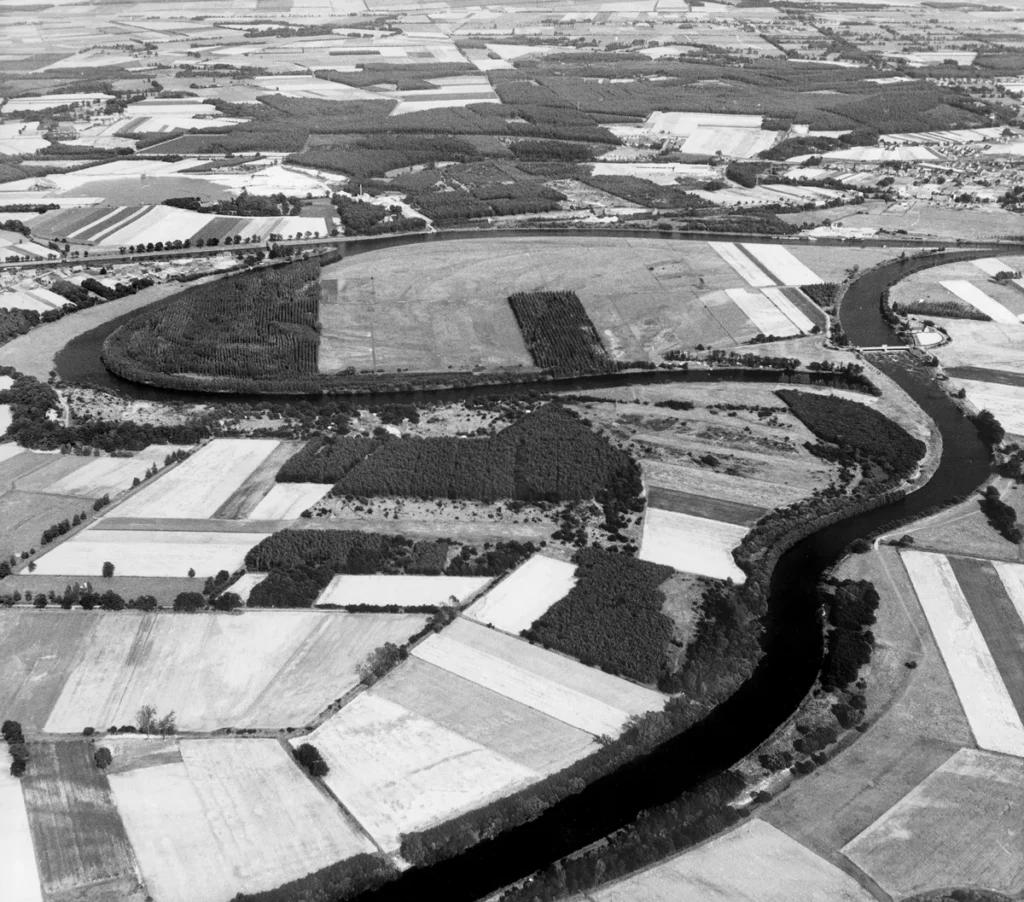 Luftaufnahme einer weitläufigen Ems-Flussschleife mit landwirtschaftlichen Feldern und mäanderndem Flussverlauf im Emsland.